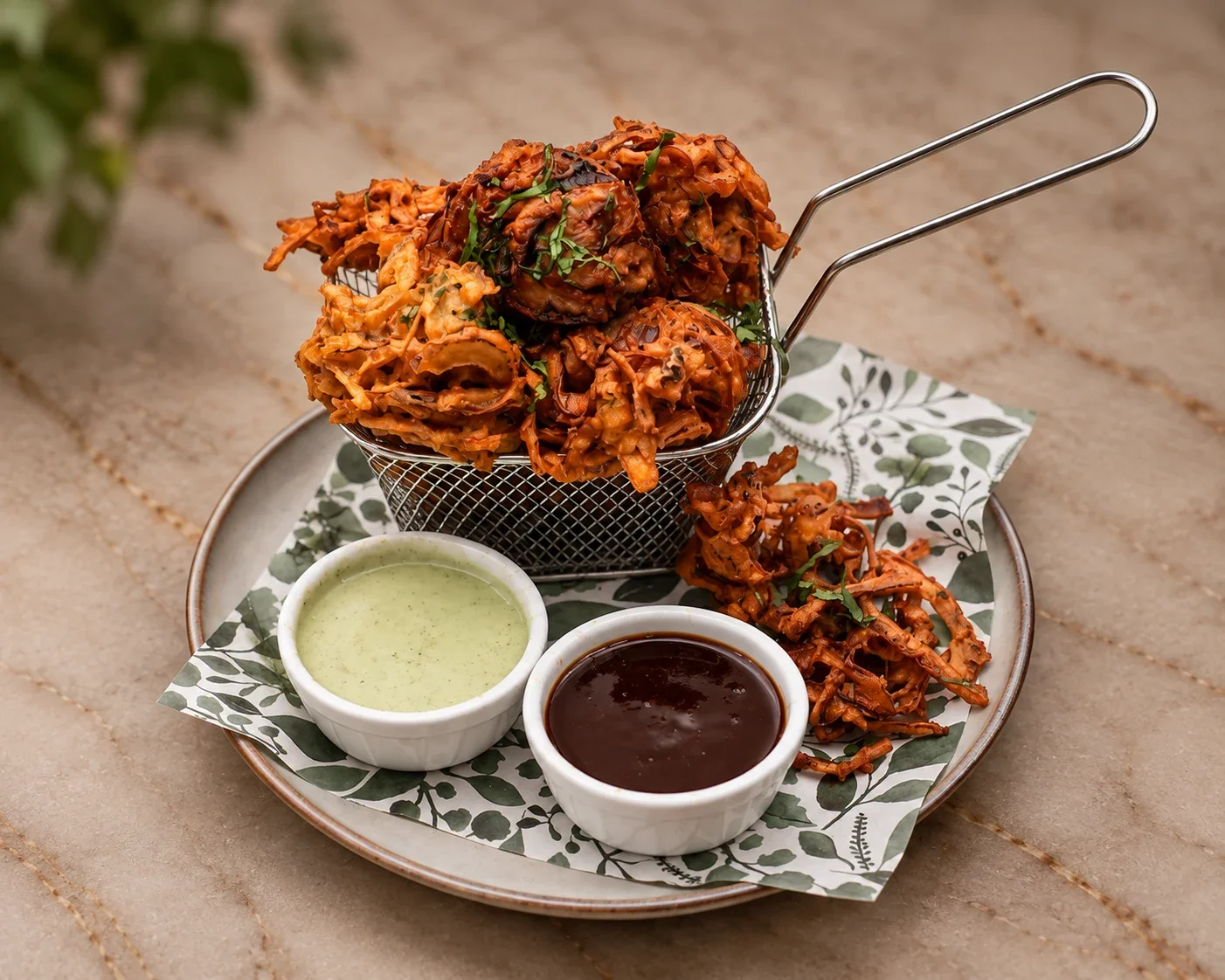 Golden Onion Pakora fritters with house chutneys at Sevana