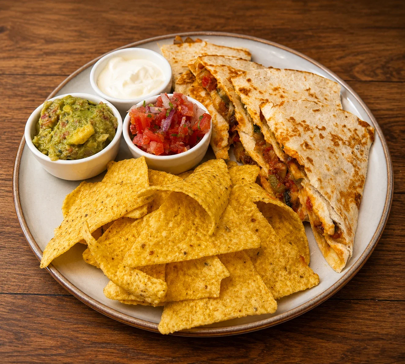 Mexican Quesadilla wedges with tortilla chips, salsa and guacamole at Sevana